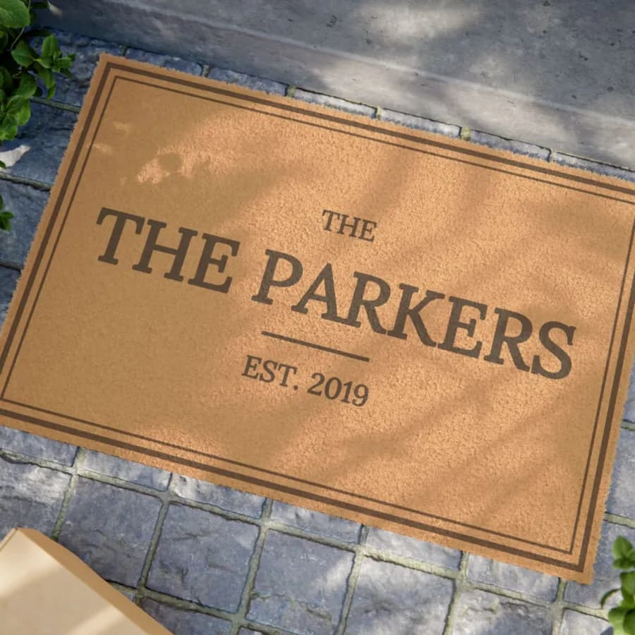 Example: porch mat reading The Parkers, EST. 2019, at a front door