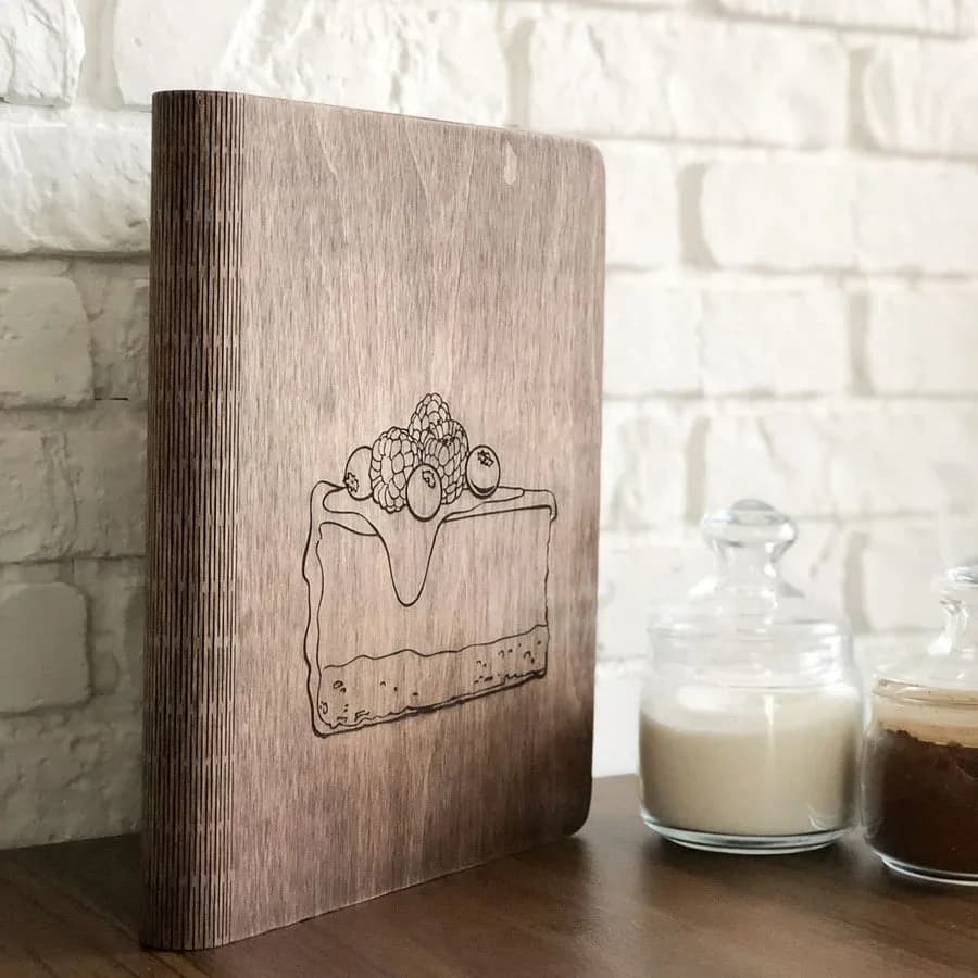 Example: engraved wooden recipe book standing on a kitchen counter